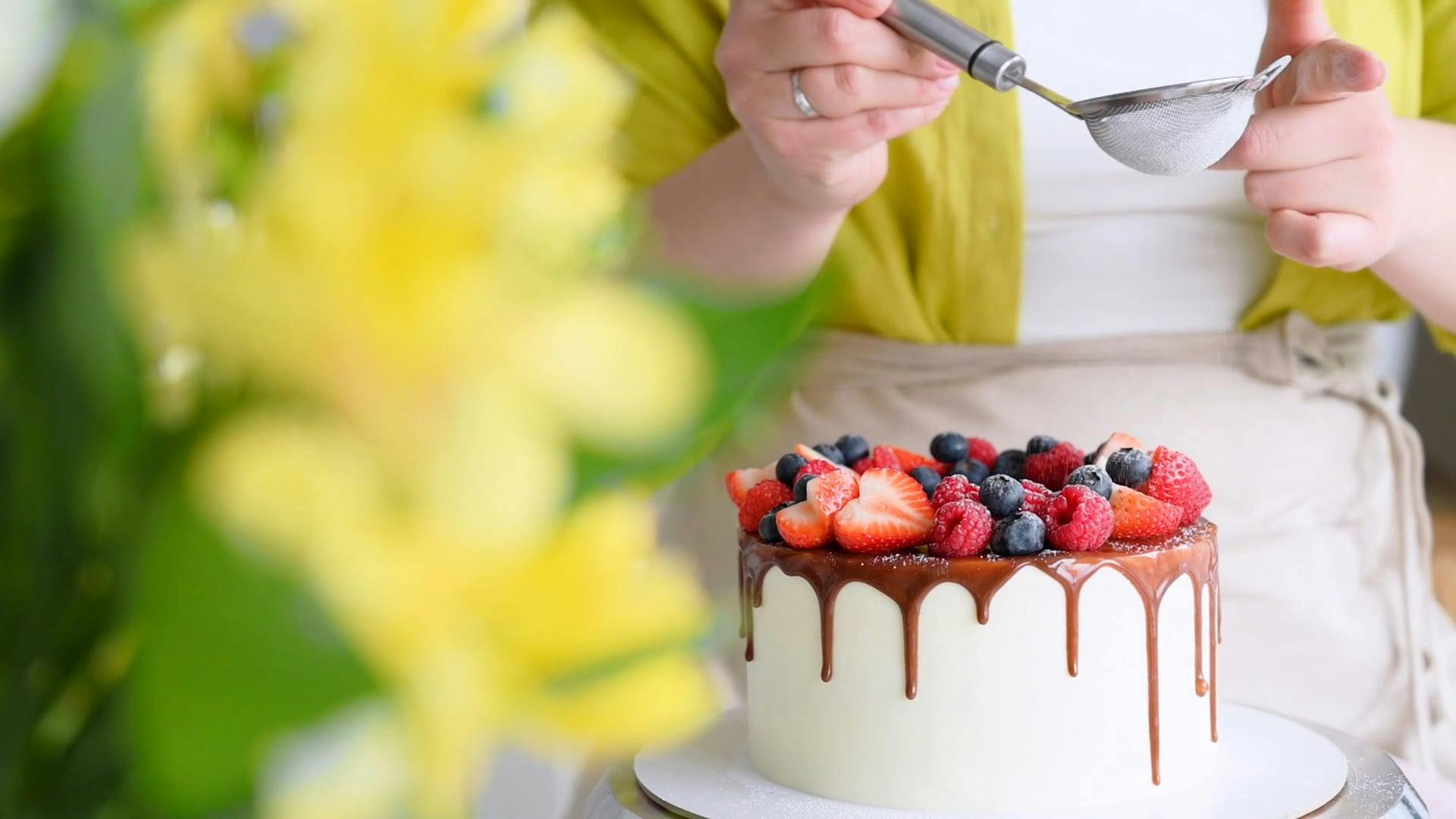 A Woman Sifting Powdered Sugar on a Cake Free Stock Video Footage