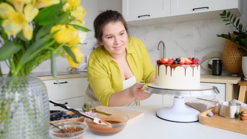 Woman Rotating a Cake Stand