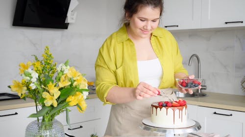 Woman Decorating a Cake