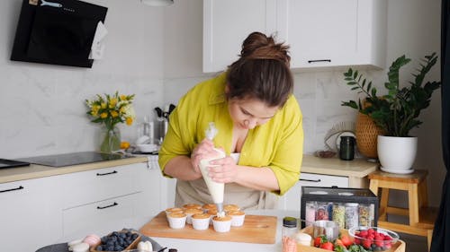 Woman Decorating Cupcakes