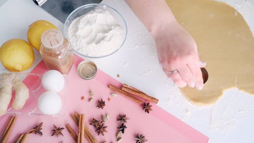 Person Cutting a Dough