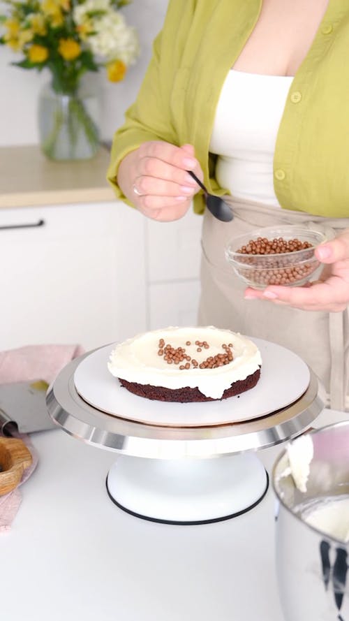 A Woman Decorating a Cake