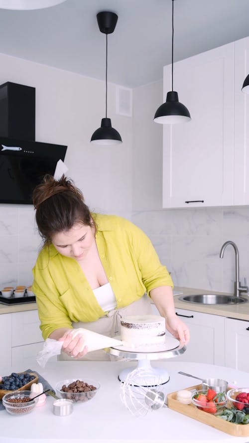 Woman Decorating a Cake