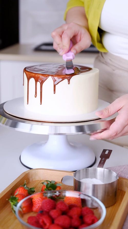 A Person Decorating a Cake