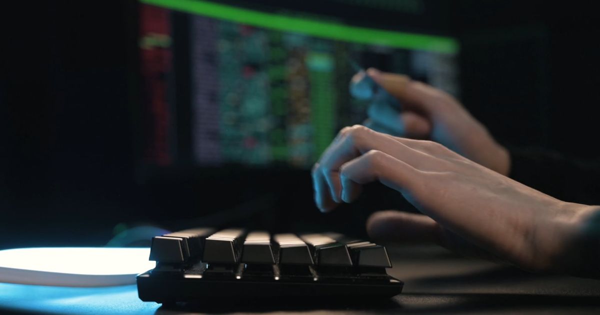 a person typing on a computer keyboard while holding a card 7534263 — free pexels stock footage