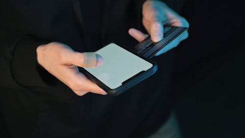Person Holding Credit Card and Smartphone