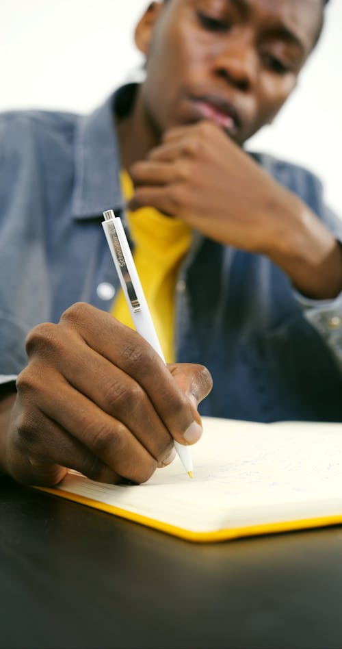 Man Writing on notebook