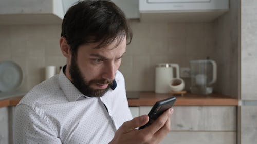 Man Getting Shocked While Using Cellphone