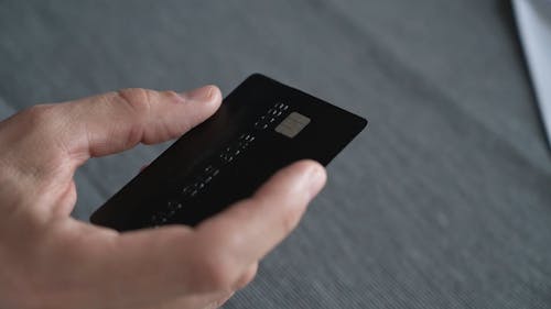 Close Up Shot of a Man Holding a Credit Card