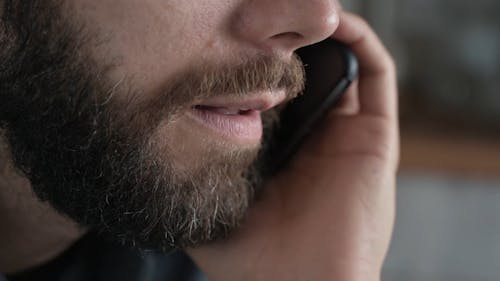 Close Up Shot of a Man Talking on the Phone