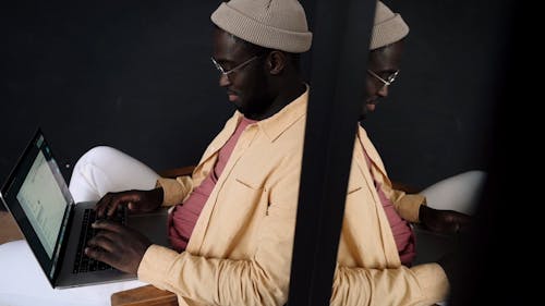 A Man Typing on Laptop