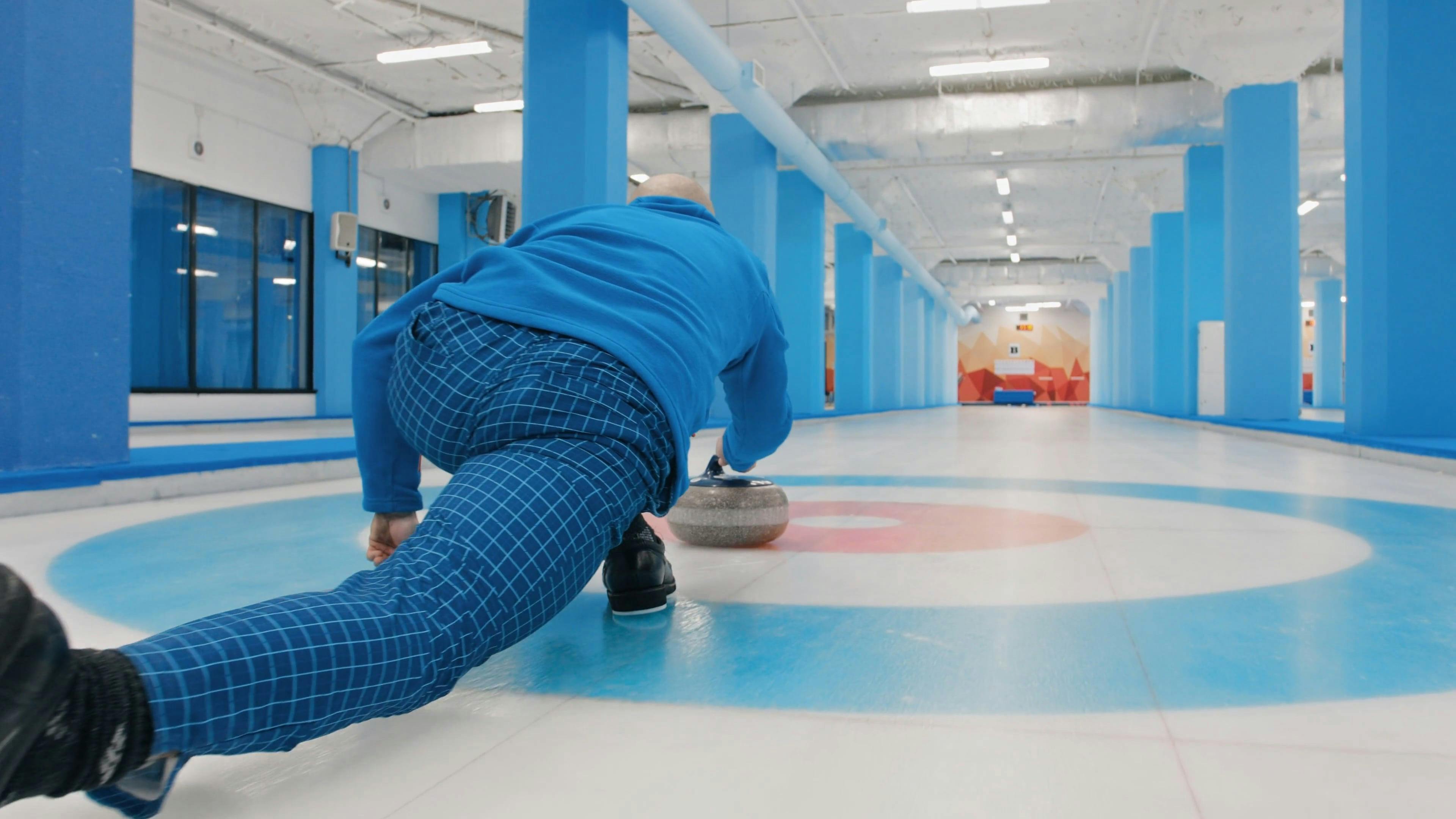 Sliding a Curling Rock on Ice · Free Stock Video