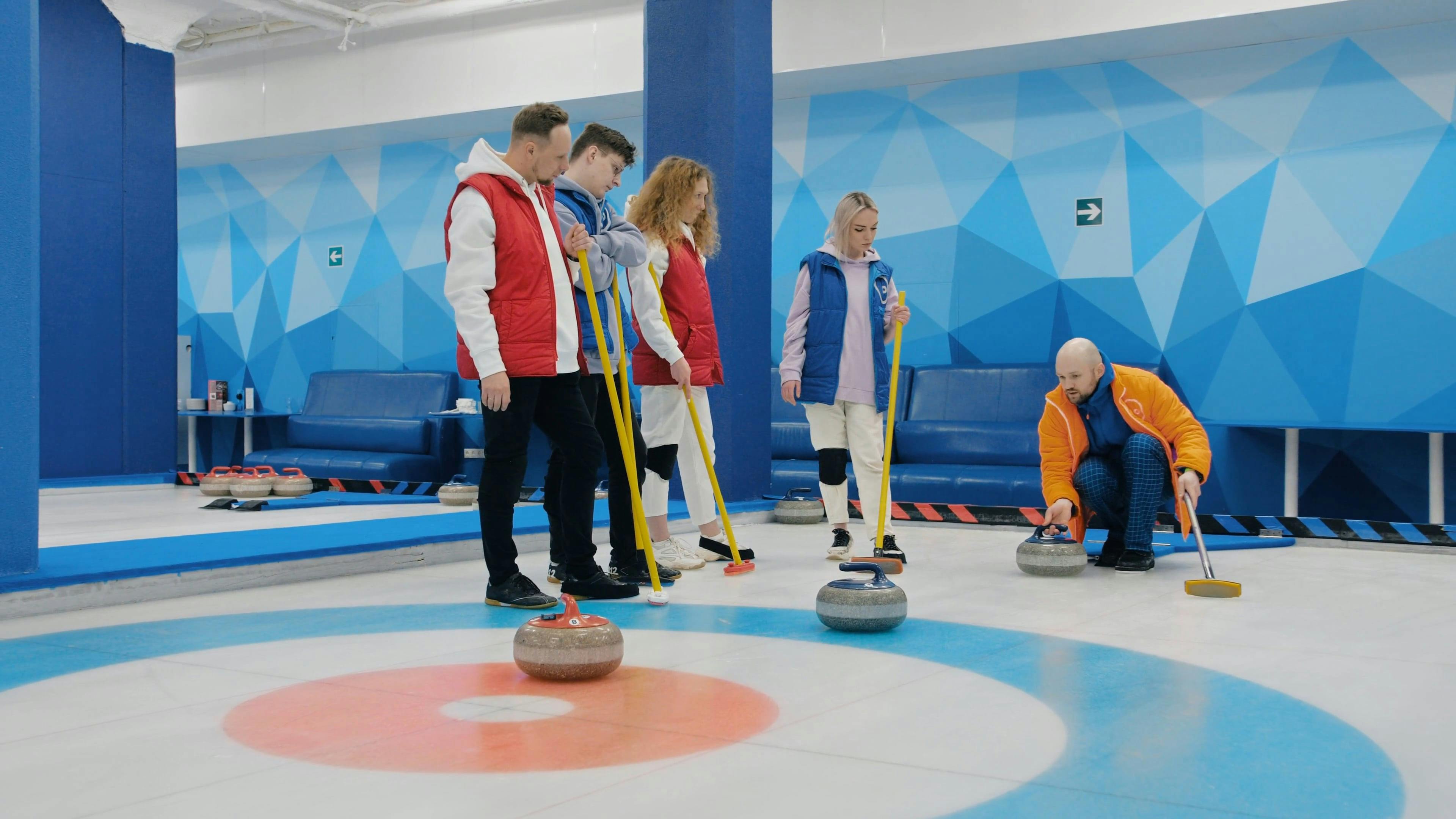 A Person Teaching a Teams How to Play Curling · Free Stock Video