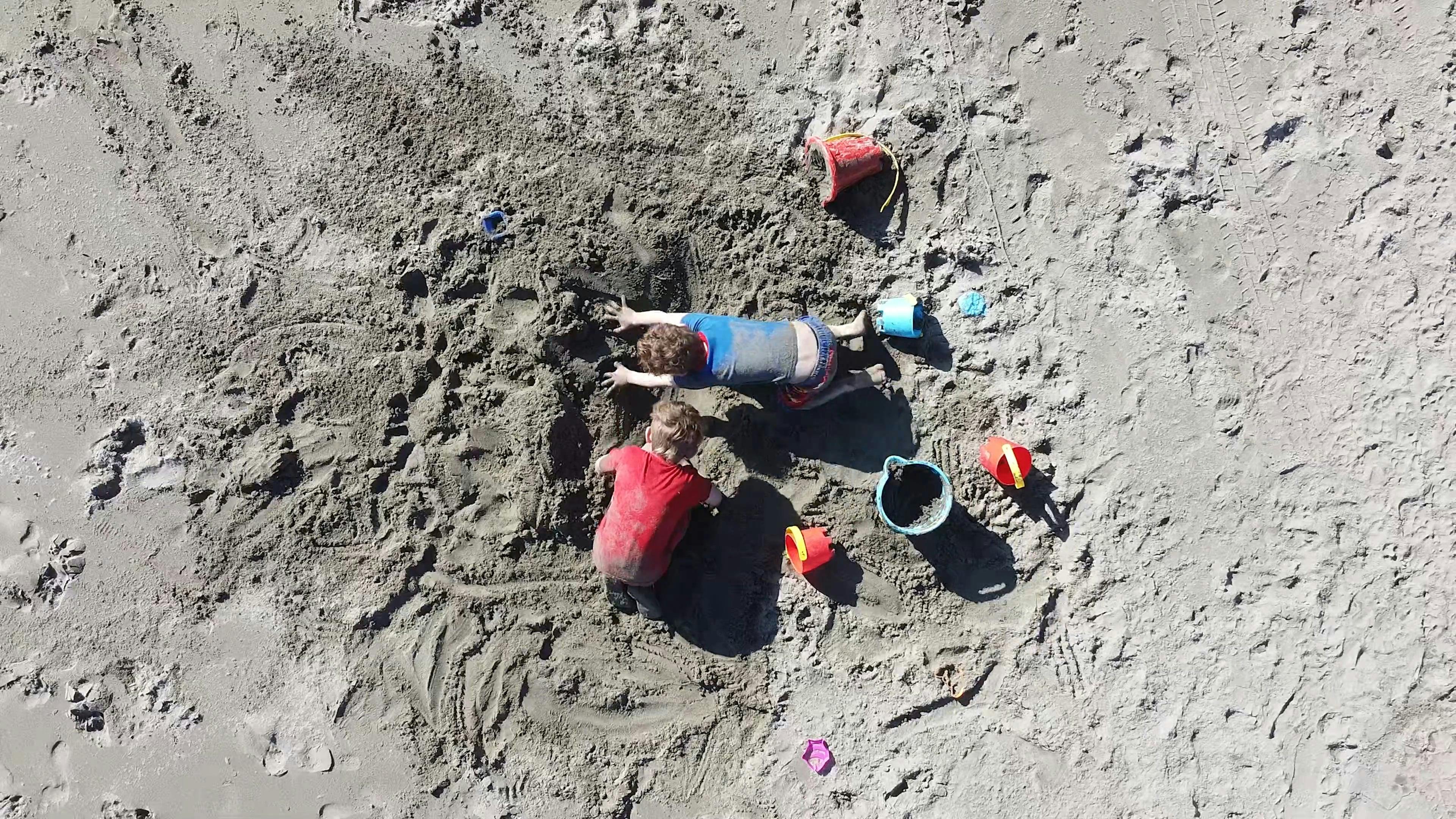 Man pouring a Bucket of Water over a Boy Head · Free Stock Video