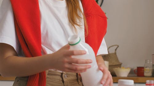 Person Throwing Plastic Bottle Into Bin