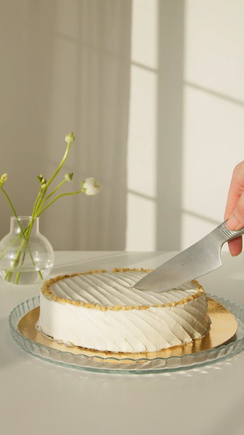 Person Slicing a Cake