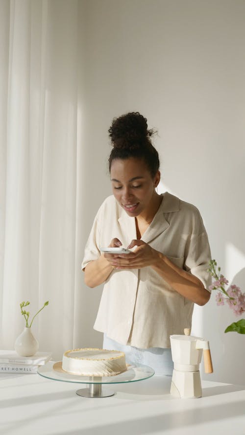 Woman Taking Picture of the Cake Using Smartphone