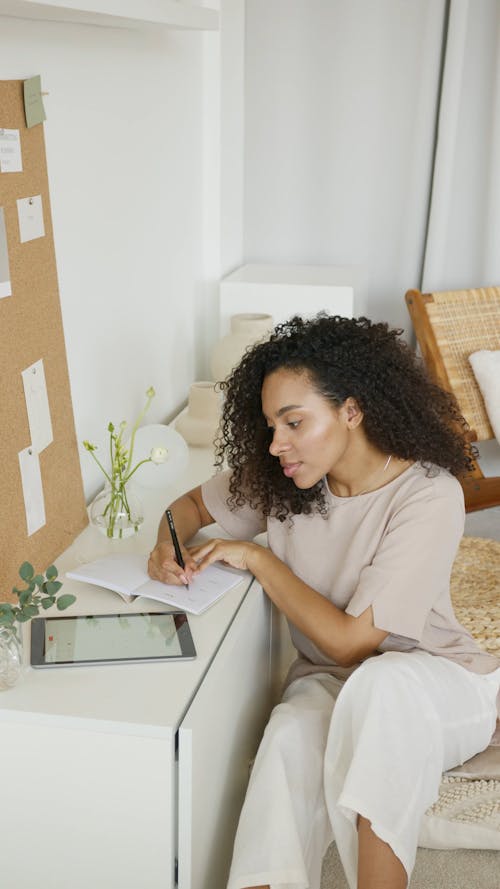 Woman with Curly Hair Using a Tablet