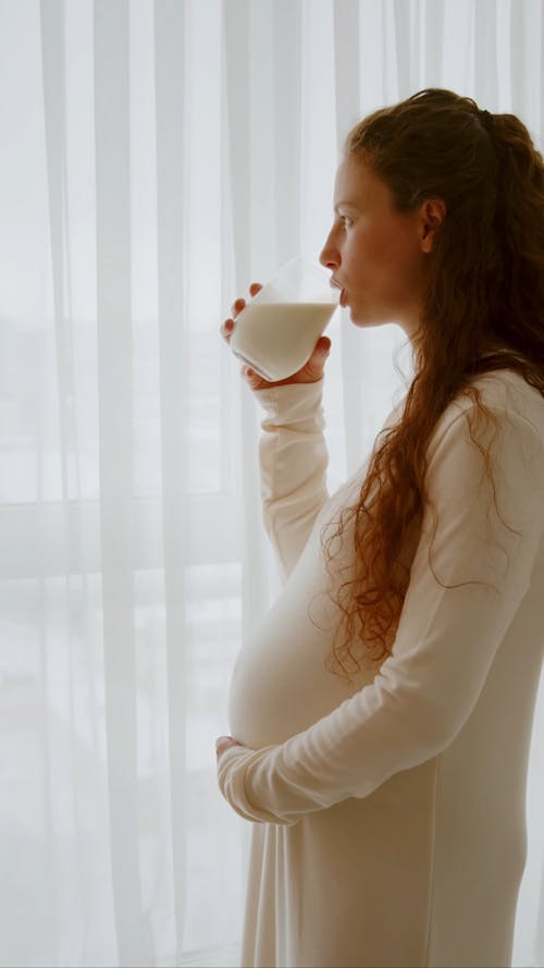 Pregnant Woman Drinking Glass of Milk