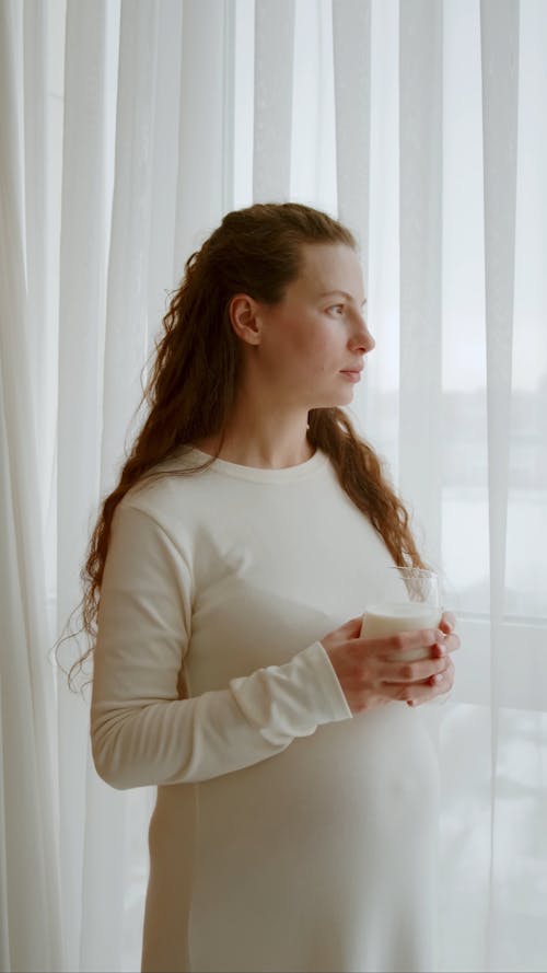 Pregnant Woman  Holding A Glass With Milk