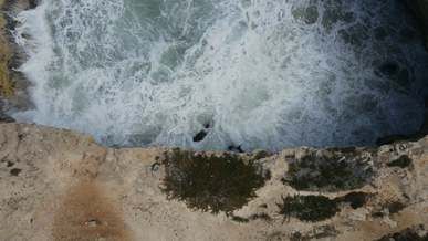sea waves crashing through a rocky shore