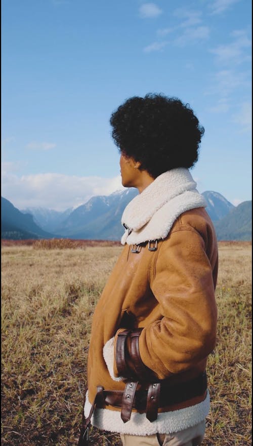 A Man Modeling Outdoors in a Brown Jacket