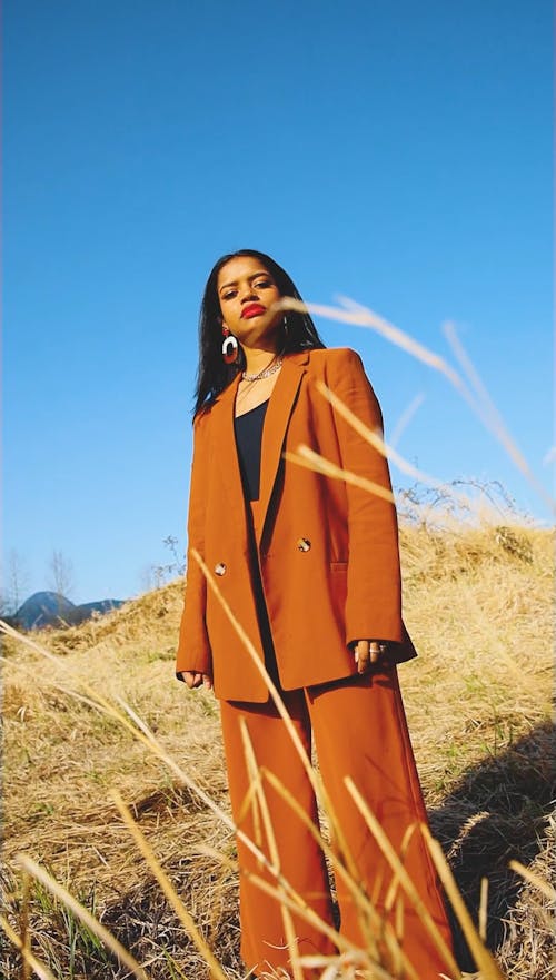 Dutch Angle of a Young Woman Posing in a Field