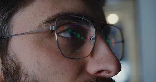 Man Looking at a Screen with Charts 