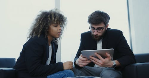 Woman and Man Working using Digital Tablet