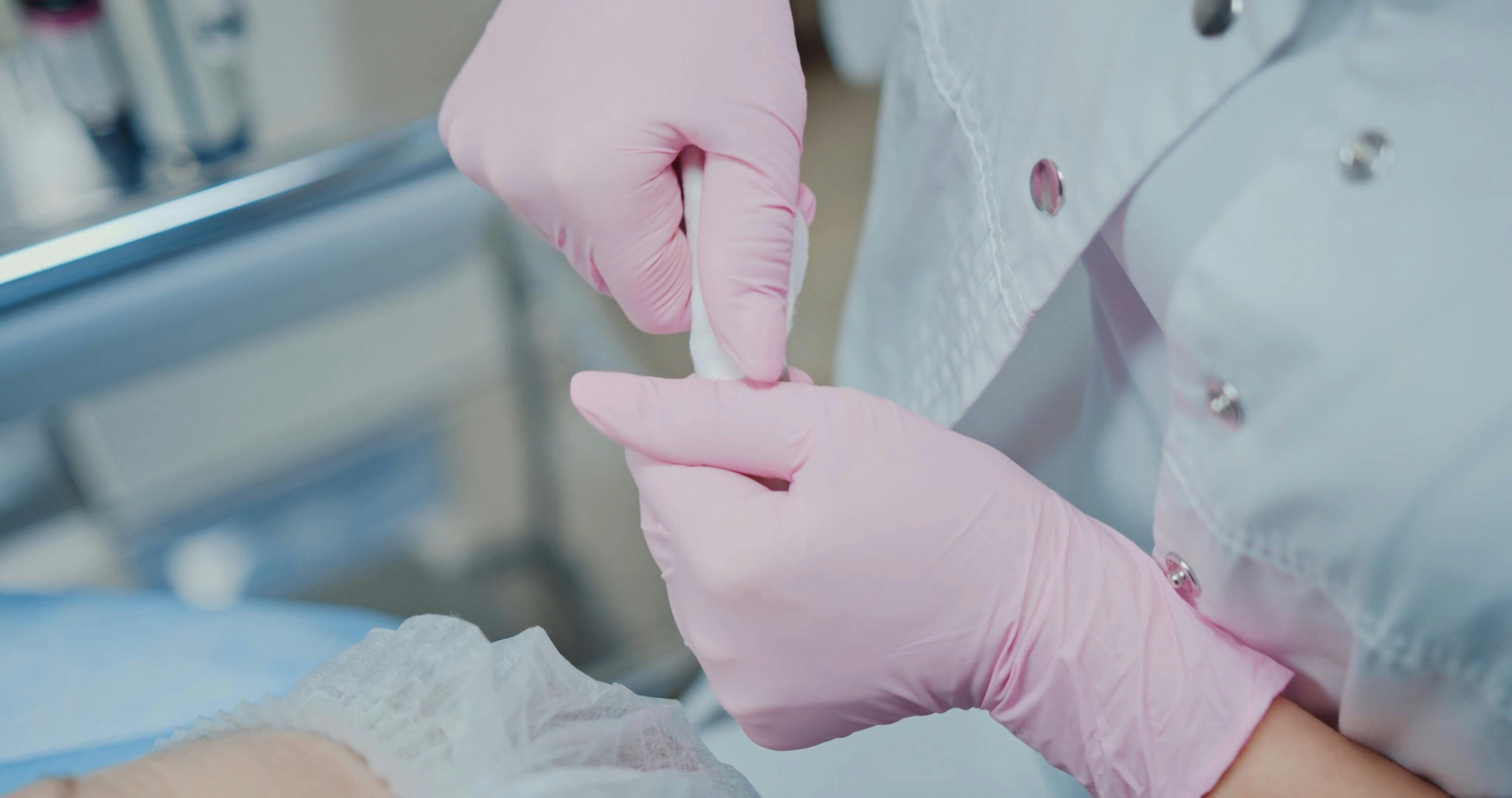 Close up of a Person Opening an Ampoule and Getting a Syringe Free
