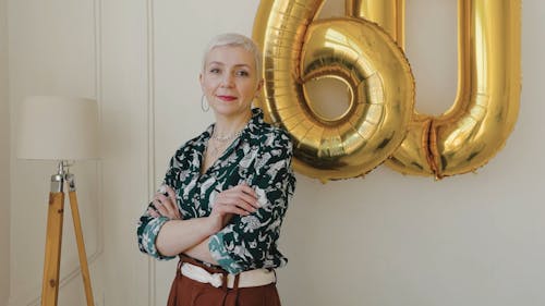 Woman Posing beside Gold Balloons