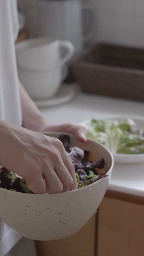 Person Holding a Salad Bowl