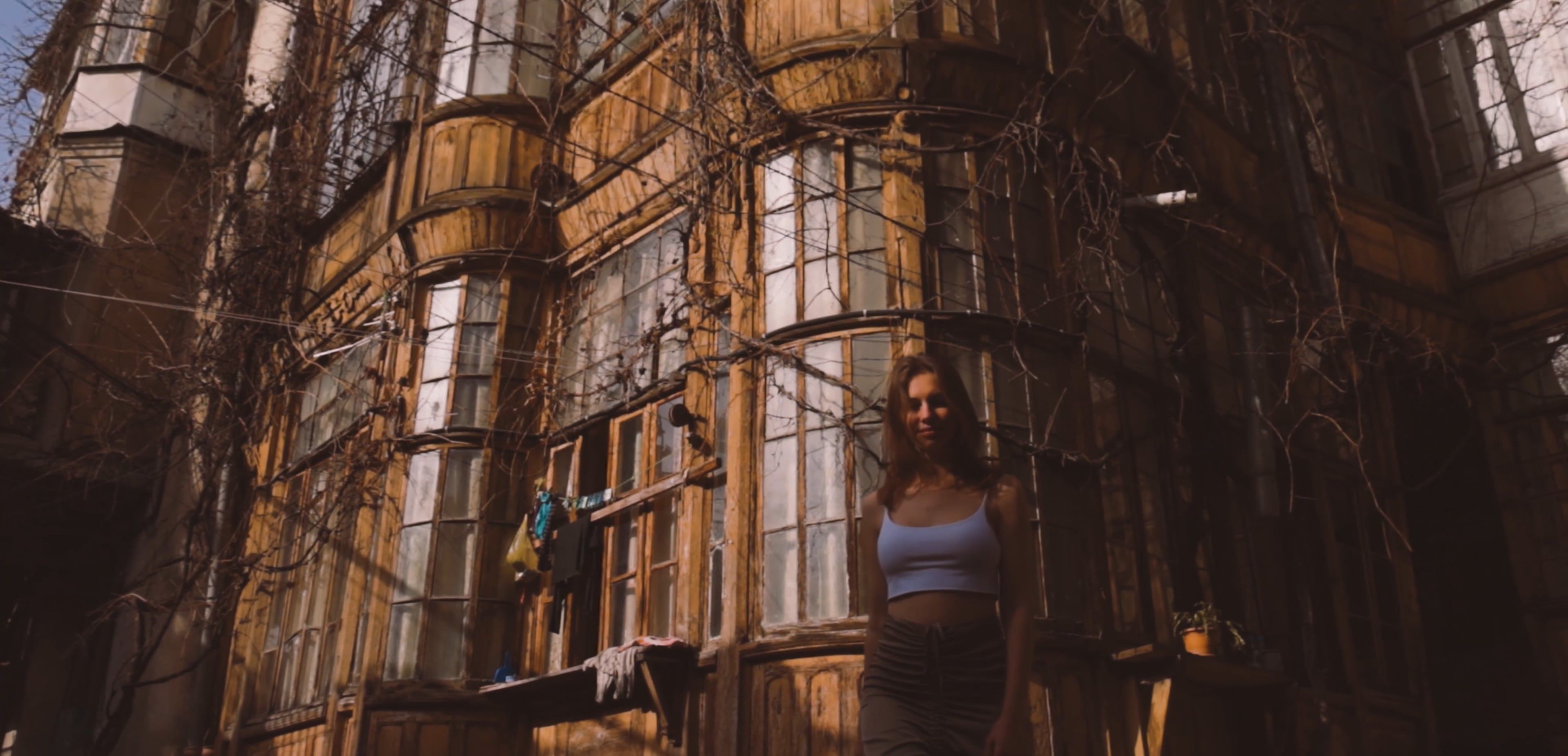 Woman Walking Away From An Abandoned Building · Free Stock Video