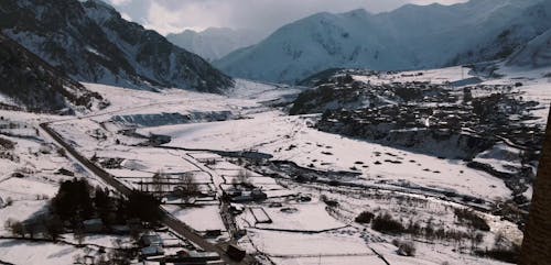 Snow Covered Field and Mountains