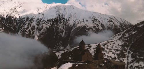 Drone Shot of an Old Castle on a Mountain Peak