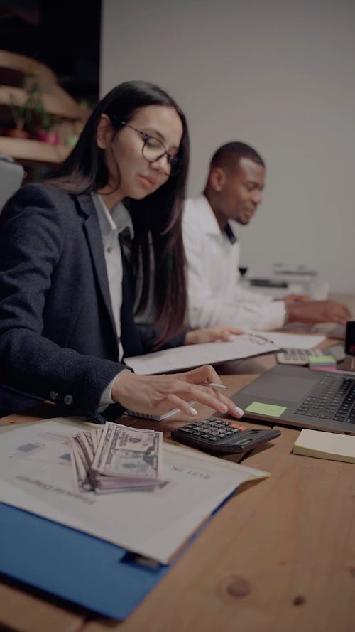 A Woman Working while using Calculator