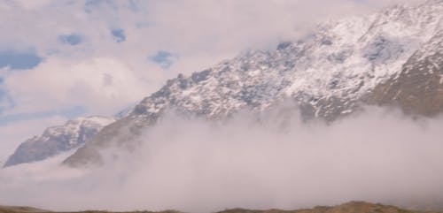 Foggy and Snow Capped Mountains