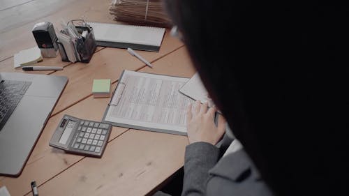 Accountant Writing on her Notebook