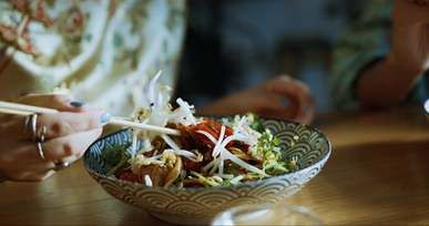 woman eating noodles