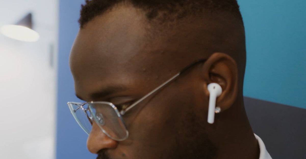 Man Calling Using Earbud Close Up View of a Man Talking While Tapping His Earbuds Free Stock ...