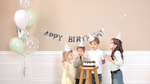 Kids Blowing the Birthday Cake