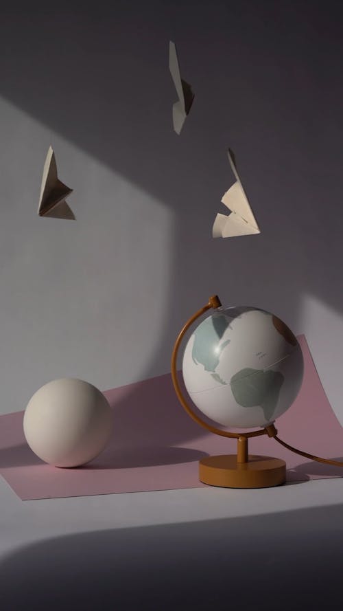 Paper Planes Hanging Over Ball Shaped Objects