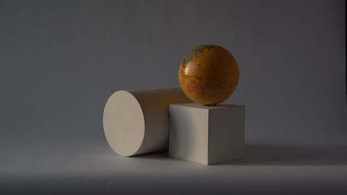 A Globe Spinning Over The Square Box