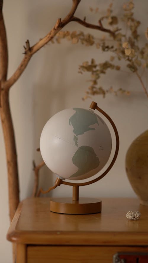 A Globe Lamp Over A Wooden Table