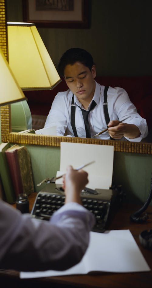 Man Writing on White Paper