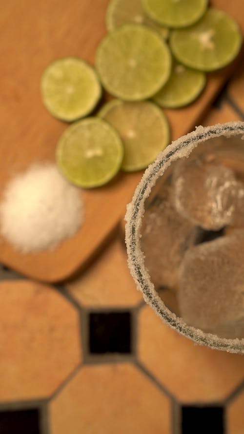 A Cocktail Drink with Salt and Lime Garnish