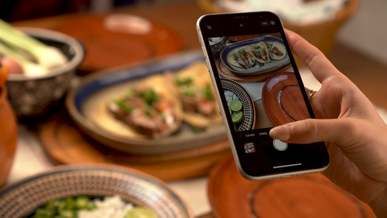 person taking photo of food