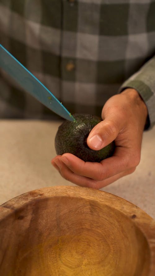 Person Slicing an Avocado