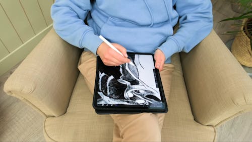 A Person Using a Digital Tablet 