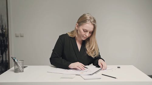 Woman Receiving a Lot of Paperwork